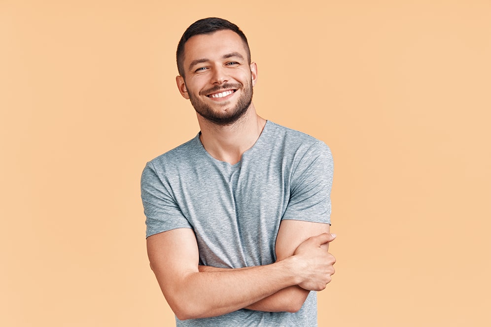 Happy smiling handsome man with crossed arms